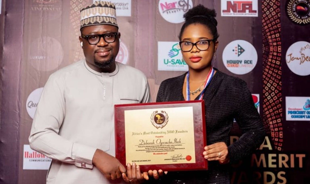 Deborah Ogwuche-Ikeh holding Africa CEO Merit Award plaque.